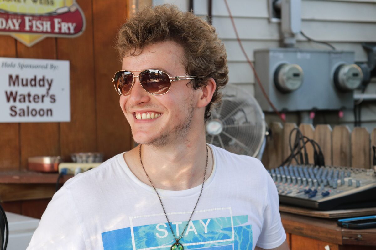 Ryan Howe casual outdoor headshot wearing aviator sunglasses, smiling
